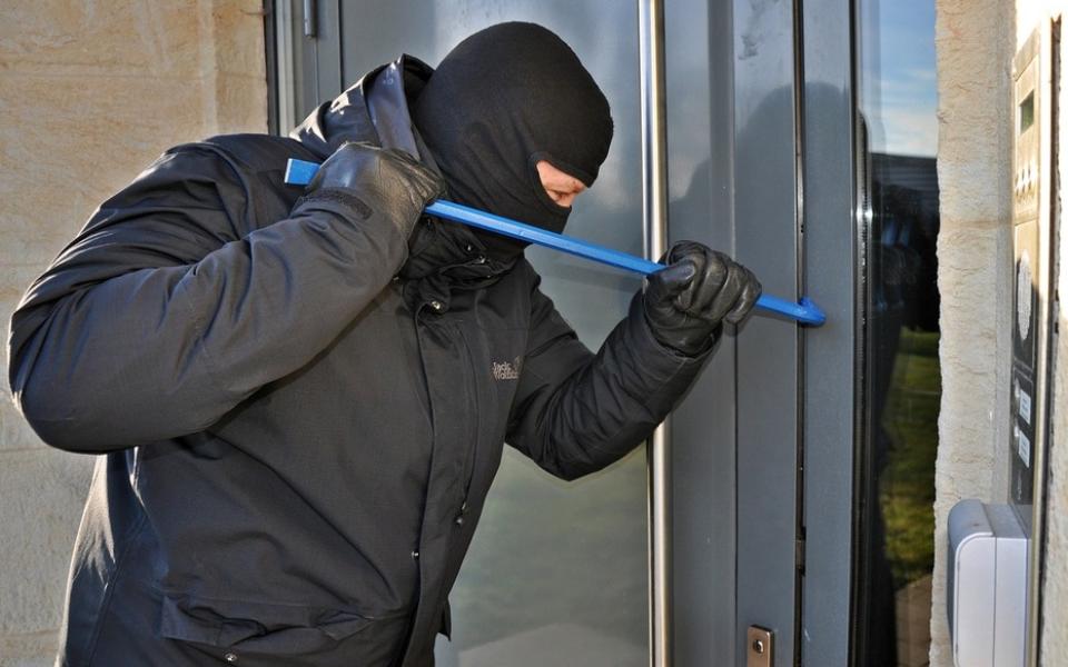 Burglar breaking into a house