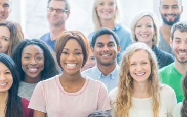 Group of people together, smiling at the camera