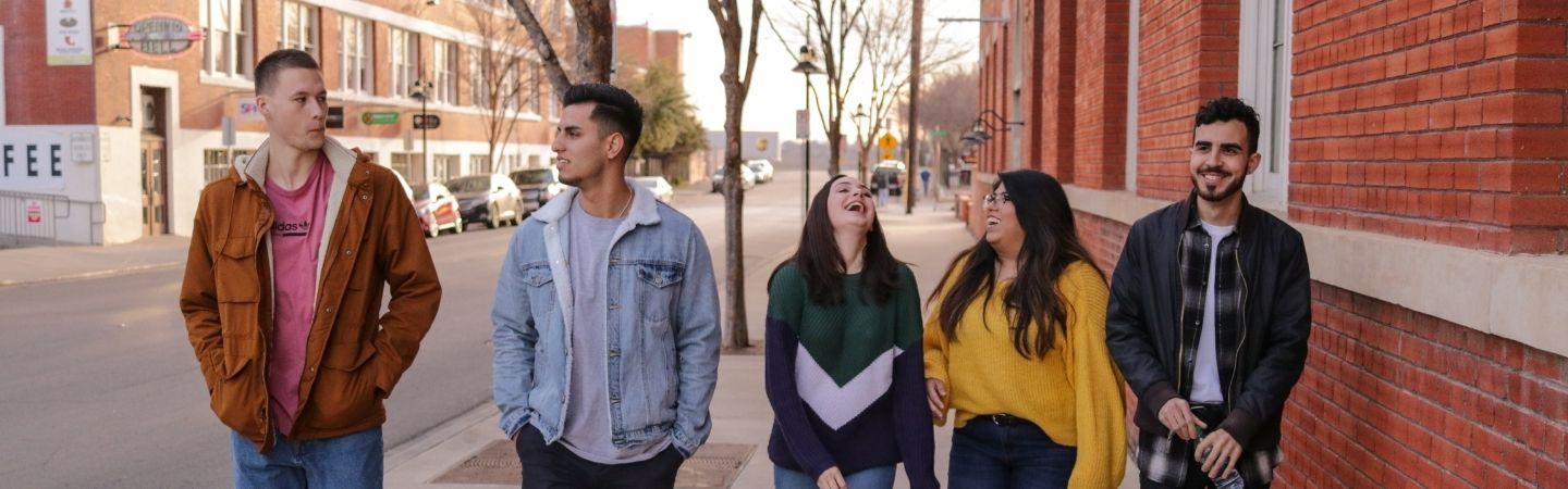 Young people walking in a street together, posed photo